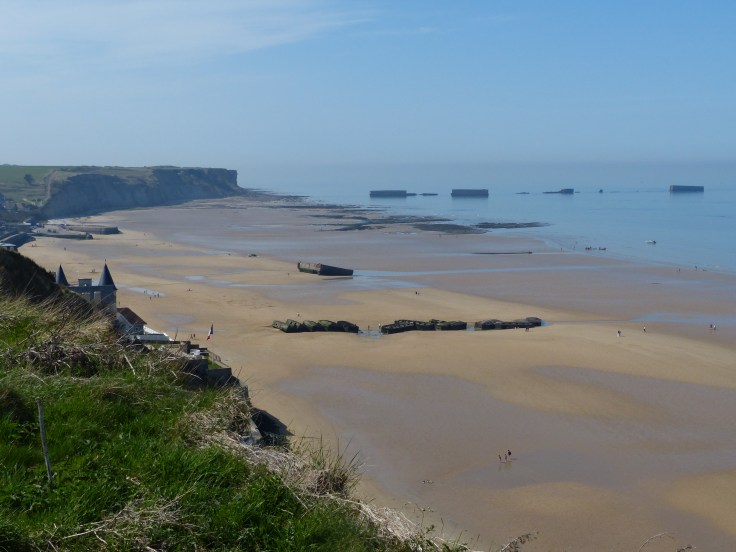 Gold Beach with remains of the floating harbour in the background
