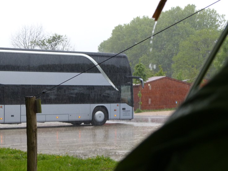 ...in the pouring rain on the edge of the bus car park...
