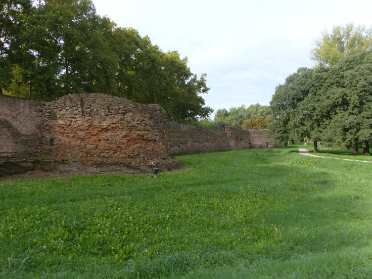 Riding into Ferrara beside the old city walls