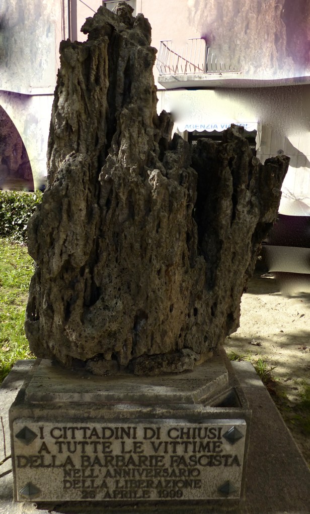 This looked like a petrified tree trunk. The plaque reads 'From the citizens of Chiusi to all victims of fascist barbarism on the anniversary of the liberation'