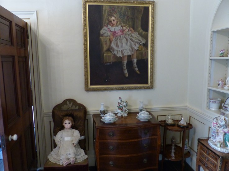 A painting of Agatha Christie as a four year old, and the actual doll she's holding in the painting