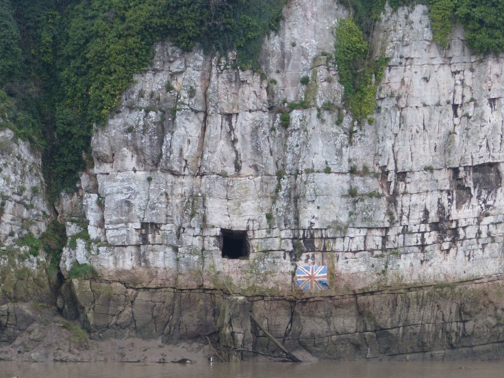 This is the Gloucester Hole, a naturally occurring cave, which is thought to have been  used to store tea by Quakers and gunpowder by the railways. The hole opens out into a large cavern inside the hill. I thought the painted Union Jack was modern day graffiti, but it was painted by some salmon fishermen in 1935 to make King George V's Silver Jubilee